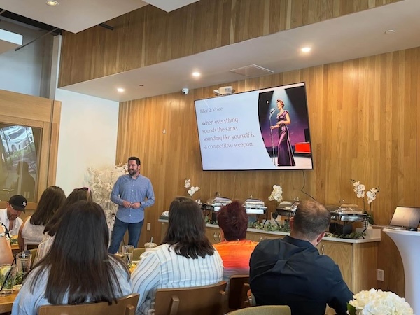 Rob speaking in front of a group of business owners about AI and marketing at the Local Table in The Woodlands, Texas